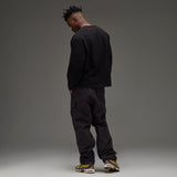 Black Undefeated Utility Pant with multiple pockets and relaxed fit, designed for comfort and style.