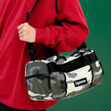 Supreme utility sling bag in snow camo pattern, featuring adjustable strap and multiple compartments for everyday use.