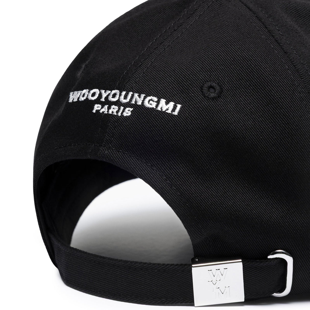 Black Wooyoungmi WYM logo cap, stylish headwear with adjustable strap and embroidered branding, perfect for casual wear.
