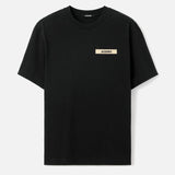 Black Jacquemus Grosgrain Logo Tee with visible logo detail, styled as a casual apparel piece from MASTERMIND JAPAN.