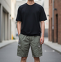 Olive AAPE By Bathing Ape badge cargo shorts with side pockets and logo patches, casual streetwear apparel for men.