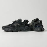 Black New Balance 9060 Mule sneakers with sleek design, showcasing the comfortable slip-on style and modern athletic look.