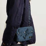 Porter Yoshida Japan Tanker Envelope Bag in navy with sleek design, featuring a compact, stylish bag with a flap closure and signature branding.