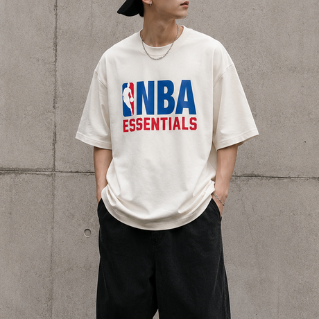 Cream Fear of God Essentials NBA 90s Heavyweight Tee, casual men's apparel with bold graphic design and comfortable fit.
