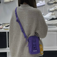 Supreme purple box logo sling bag with adjustable strap and compact design, ideal for casual carry and streetwear style.