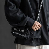 Black Human Made Military Mini Sling Bag with adjustable strap and compact design, ideal for carrying essentials.