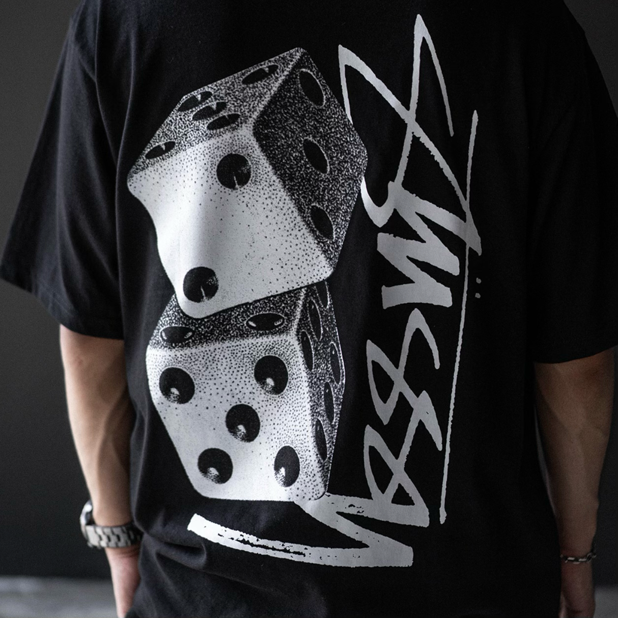 Black Stussy Tall Dice Tee shirt with bold dice graphic print, casual streetwear style, front view, apparel by Stussy.
