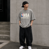 Fear of God Essentials NBA 90s Heavyweight Tee in concrete heather, featuring a relaxed fit and graphic design on the front.
