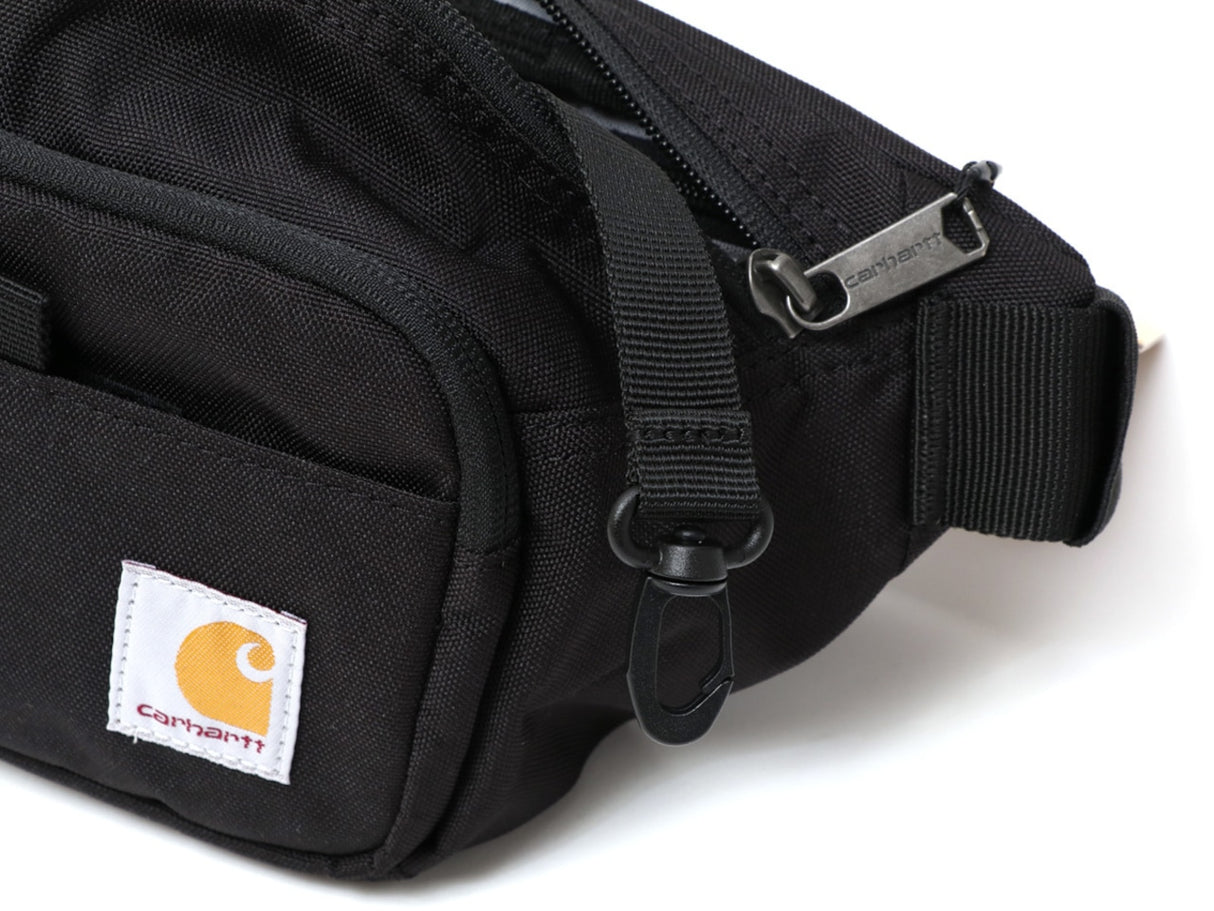 Black Carhartt Classic Waist Bag with adjustable strap and multiple compartments, ideal for casual carrying and outdoor activities.