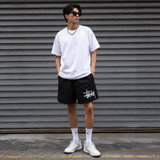 Black Stussy Basic Big Logo nylon shorts for men, featuring a bold logo design and comfortable fit.