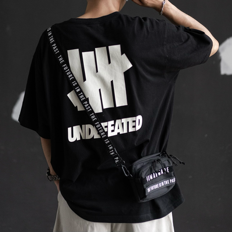 Human Made military mini sling bag in black, compact and stylish with adjustable strap and front pocket for essentials.