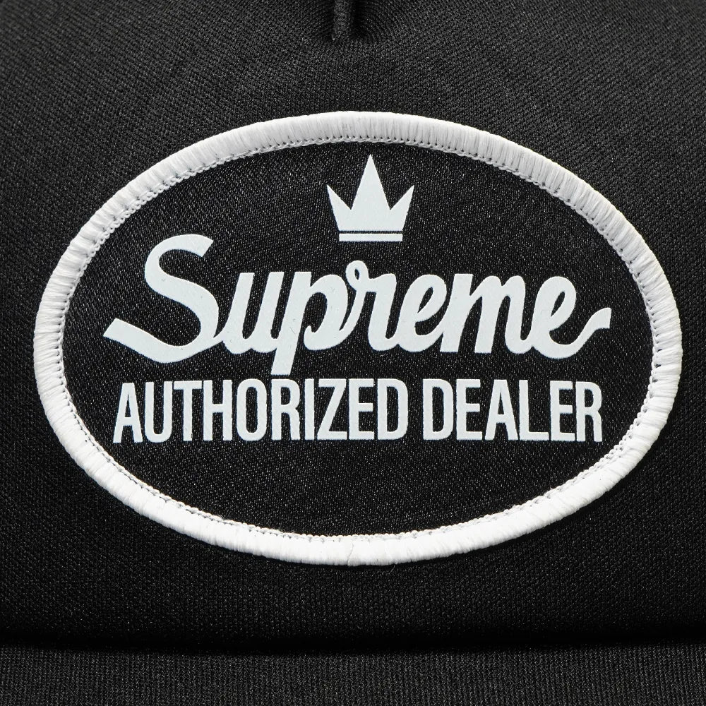 Black Supreme mesh trucker cap, a stylish headwear with mesh panels and adjustable snapback, featuring the Supreme logo.
