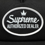 Black Supreme mesh trucker cap, a stylish headwear with mesh panels and adjustable snapback, featuring the Supreme logo.