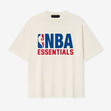 Cream Fear of God Essentials NBA 90s Heavyweight Tee, casual apparel with bold basketball-inspired design and classic fit.
