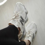New Balance 9060 Mule sneakers in off-white and mauve with a modern design and comfortable fit.