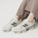 New Balance 9060 Mule sneakers in off-white and mauve with a sleek, modern design and comfortable fit.