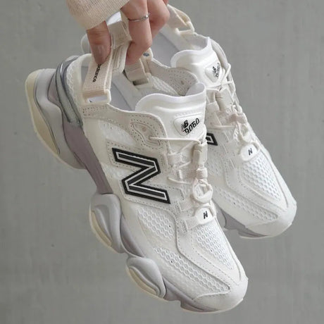 New Balance 9060 Mule sneakers in off-white and mauve with a sleek design and comfortable fit, detailed view of the footwear.