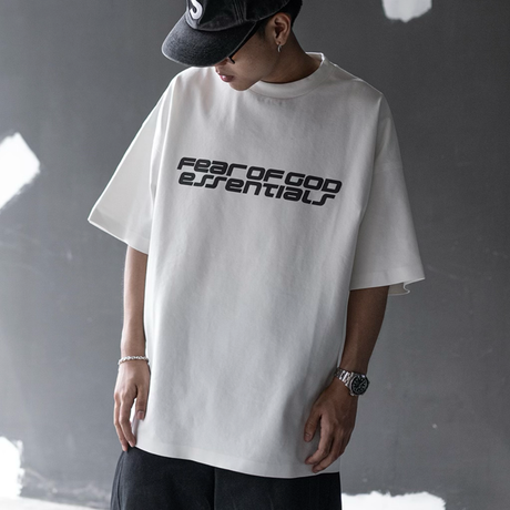 Fear of God Essentials reflective logo ponte 90s tee in ivory, featuring upgraded fabric and casual fit for everyday wear.