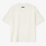 Fear of God Essentials ivory reflective logo ponte 90s tee, upgraded fabric, casual short-sleeve apparel with modern style.