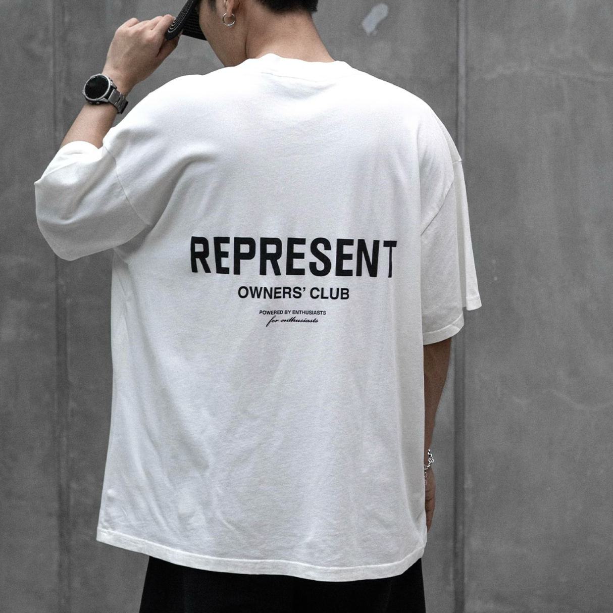 White REPRESENT Owners Club Logo Tee featuring the brand's signature graphic on a flat white cotton t-shirt.