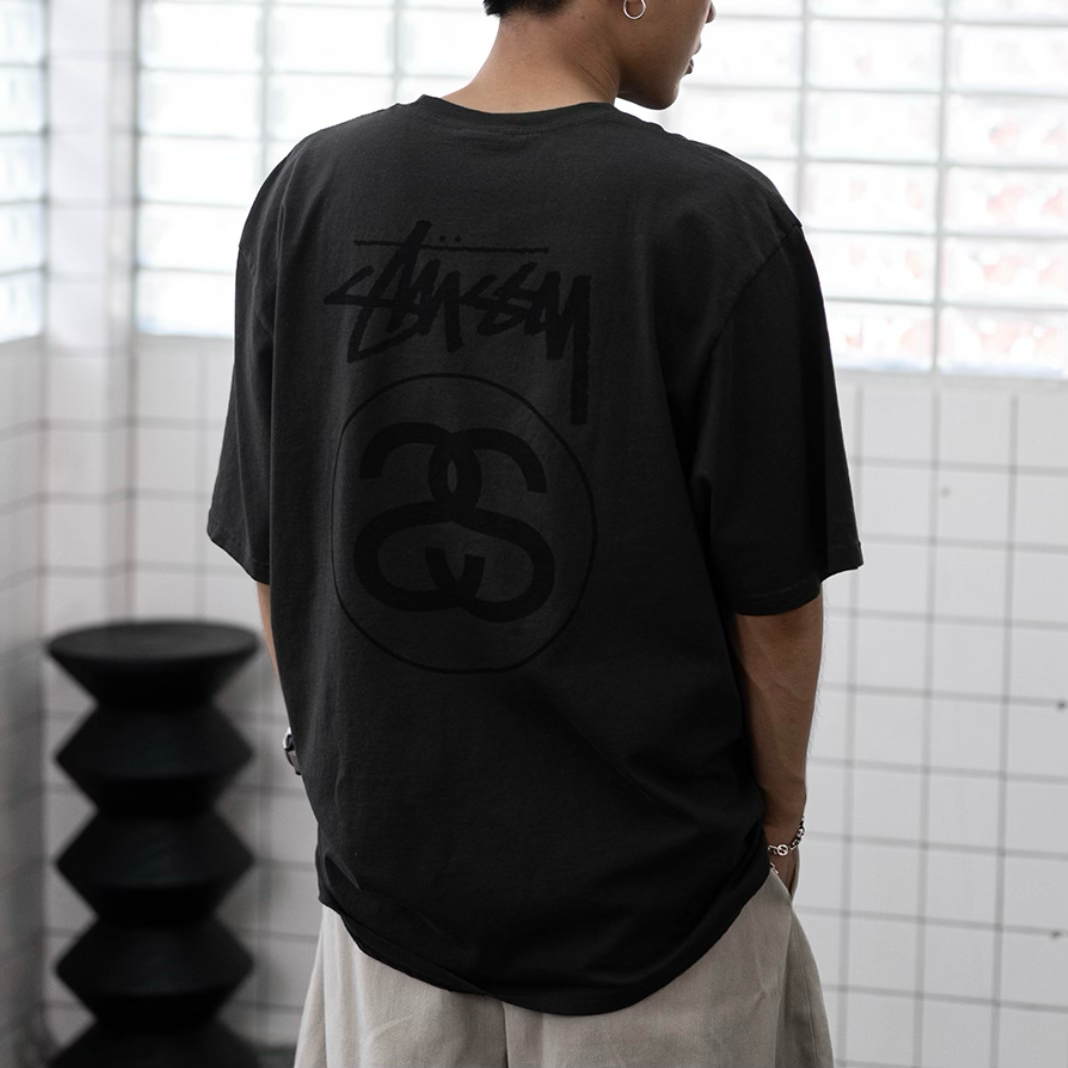 Faded black Stussy Stock Logo T-shirt displaying the iconic logo on front, casual streetwear apparel for everyday wear.