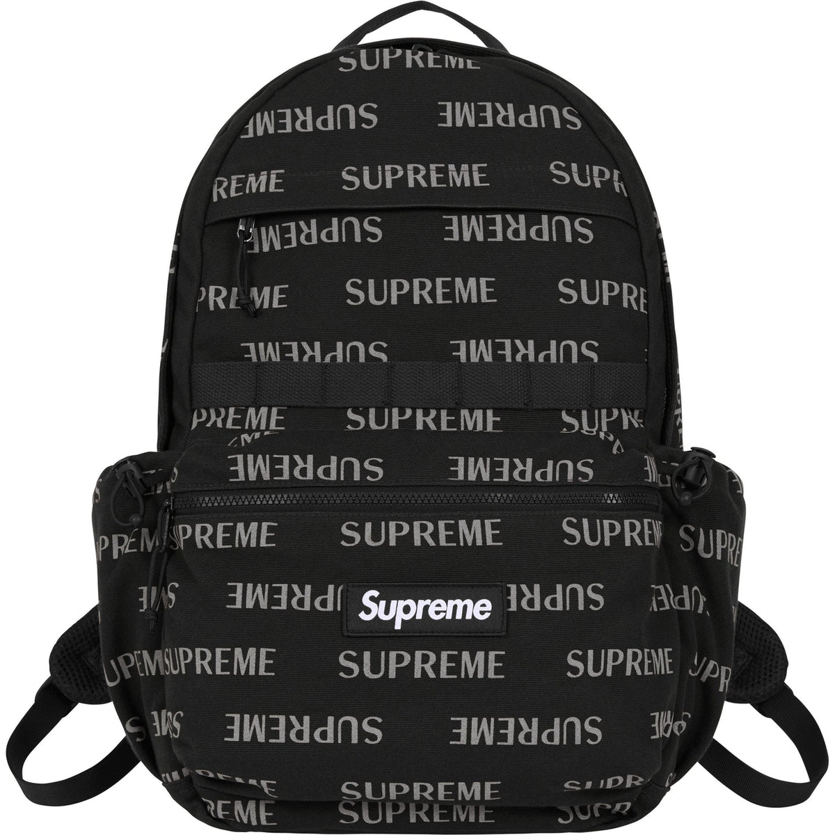 Supreme black reflective monogram logo backpack with silver logo detail, featuring multiple compartments and adjustable straps.