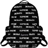 Supreme black backpack with reflective silver monogram logo, stylish bags for casual and streetwear use.