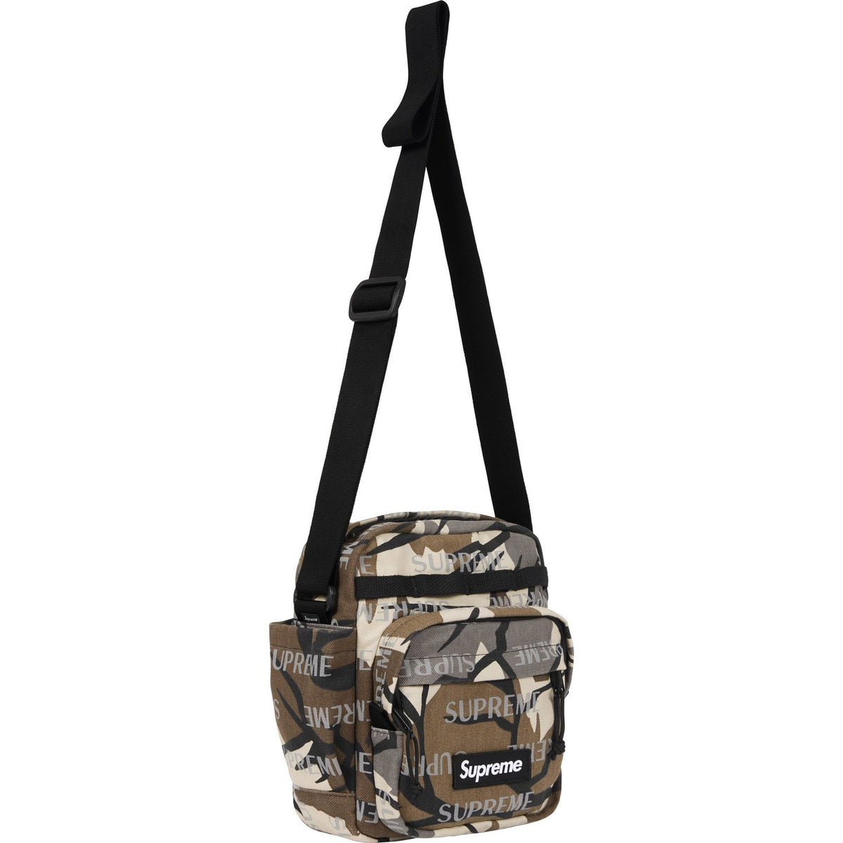 Supreme reflective monogram logo shoulder bag in predator camouflage with silver logo detail, side view showing the bag's design.