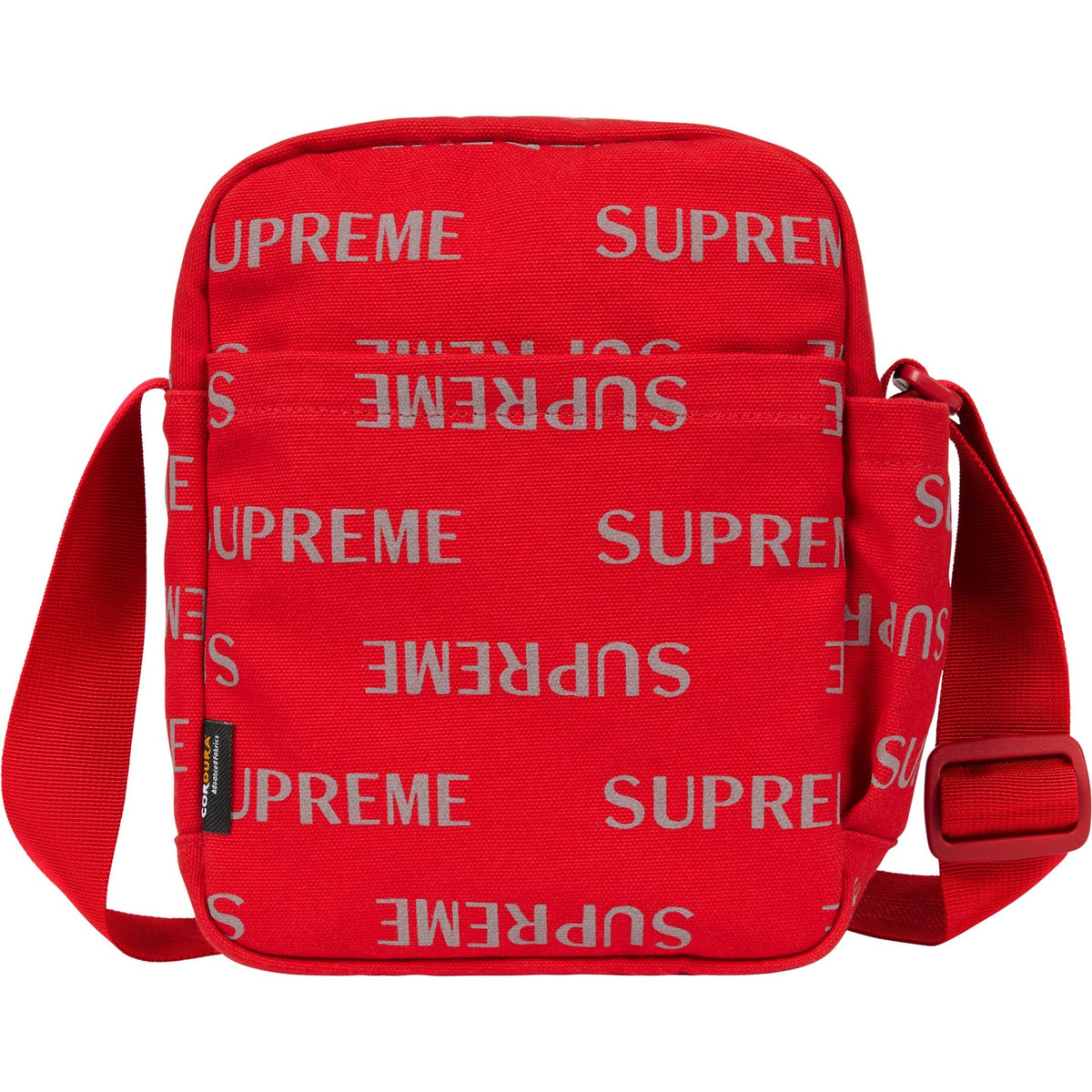 Supreme reflective monogram logo shoulder bag in red with silver logo details, showcasing side view and adjustable strap.