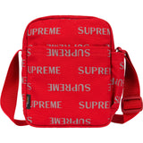 Supreme reflective monogram logo shoulder bag in red with silver logo details, showcasing side view and adjustable strap.