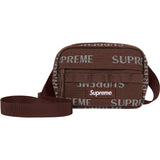 Supreme reflective monogram logo mini shoulder bag in brown with silver logo, featuring a compact design and adjustable strap.