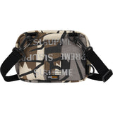 Supreme reflective monogram logo mini shoulder bag in predator camo with silver logo detail, compact and stylish accessory.