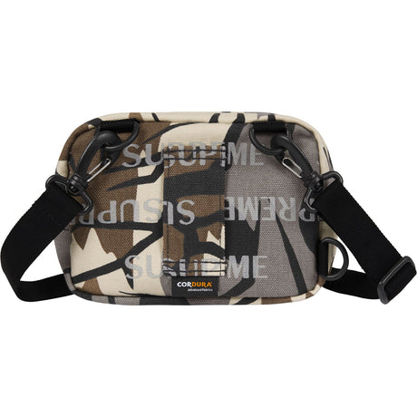 Supreme reflective monogram logo mini shoulder bag in predator camo with silver logo detail, compact and stylish accessory.
