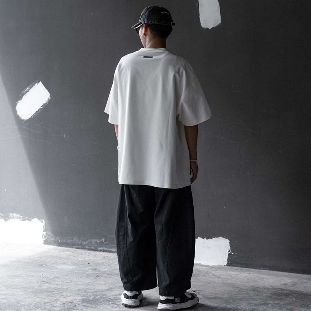 Fear of God Essentials Reflective Logo Ponte 90s Tee in ivory, upgraded fabric, casual apparel with reflective logo detail.