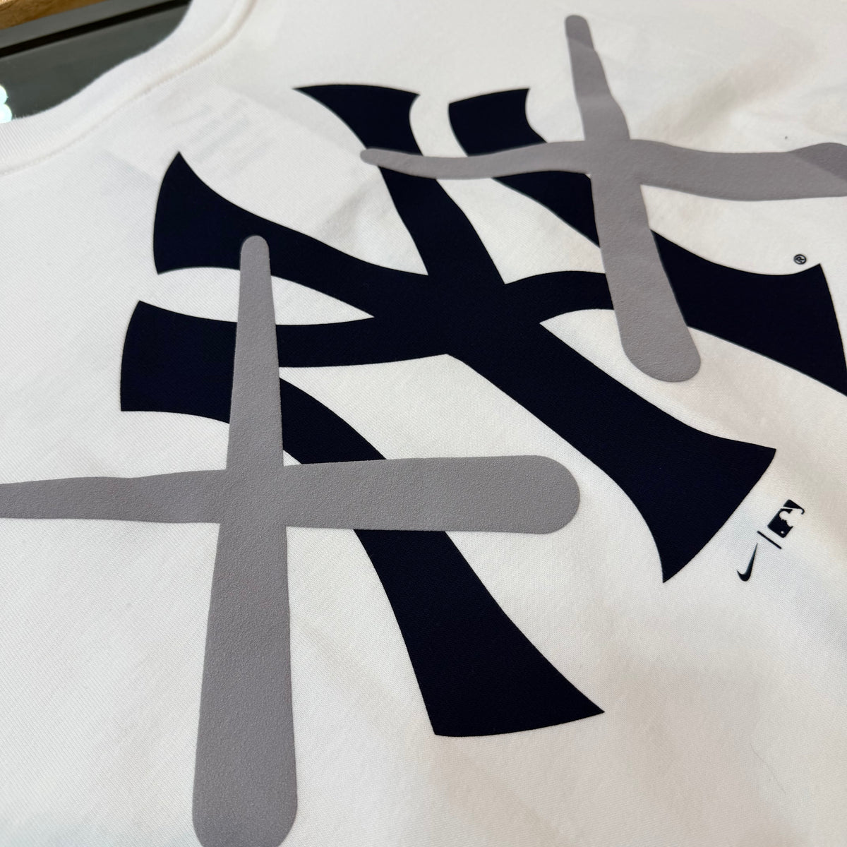 White KAWS X Nike MLB Elevated Max 90 T-shirt for men, featuring graphic design, from HUMAN MADE apparel collection.