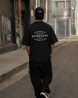 Black Represent Stamp Logo Tee featuring a bold printed logo design on the front, casual men's t-shirt.