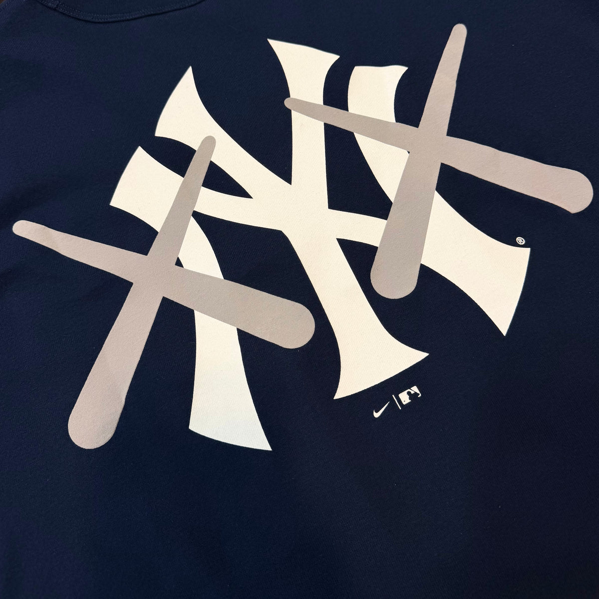 Navy KAWS X Nike MLB Elevated Max 90 tee from HUMAN MADE, featuring graphic design on the front and casual fit.