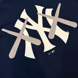 Navy KAWS X Nike MLB Elevated Max 90 tee from HUMAN MADE, featuring graphic design on the front and casual fit.