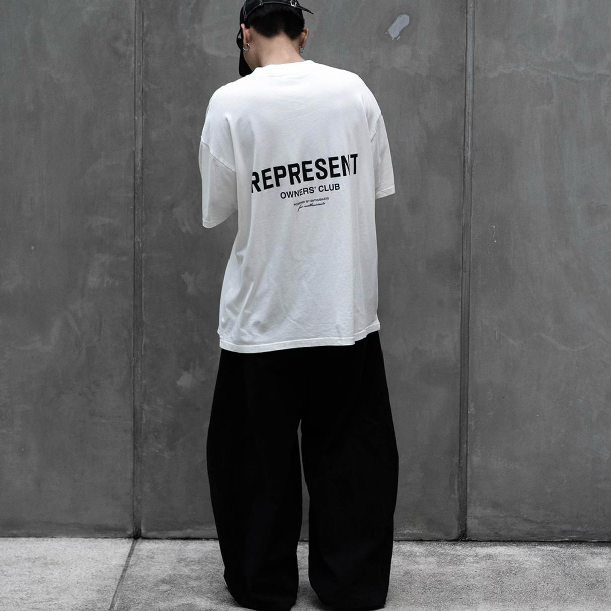 White REPRESENT Owners Club Logo Tee featuring a front printed logo design on a flat white t-shirt.
