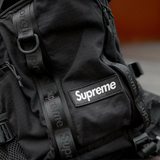 Supreme black box logo backpack with adjustable straps and front logo patch, ideal for everyday carry and casual style.