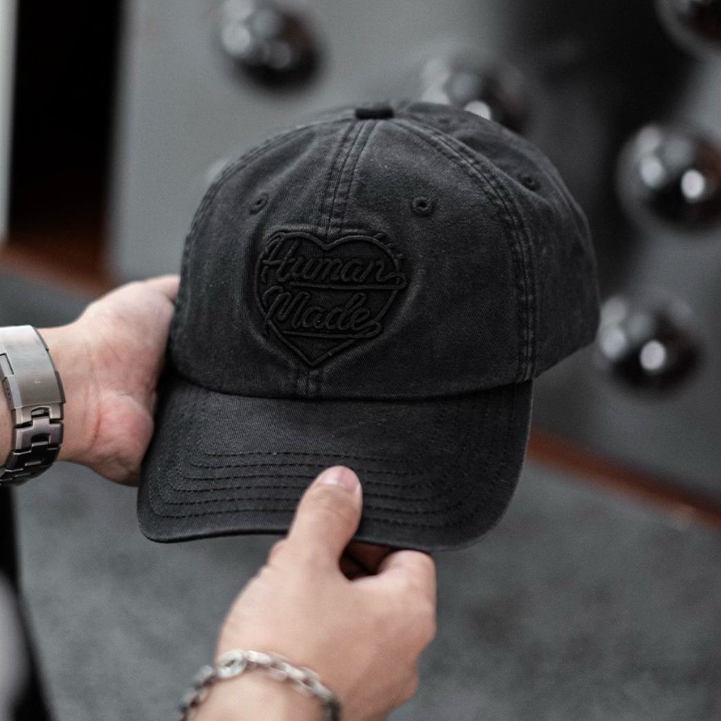 Black Human Made Heart Logo 6 Panel Cap, a stylish headwear with embroidered heart logo, perfect for casual streetwear.