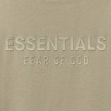 Fear of God Essentials metallic logo classic fit tee in abbey stone, showing the front view of the stylish apparel.
