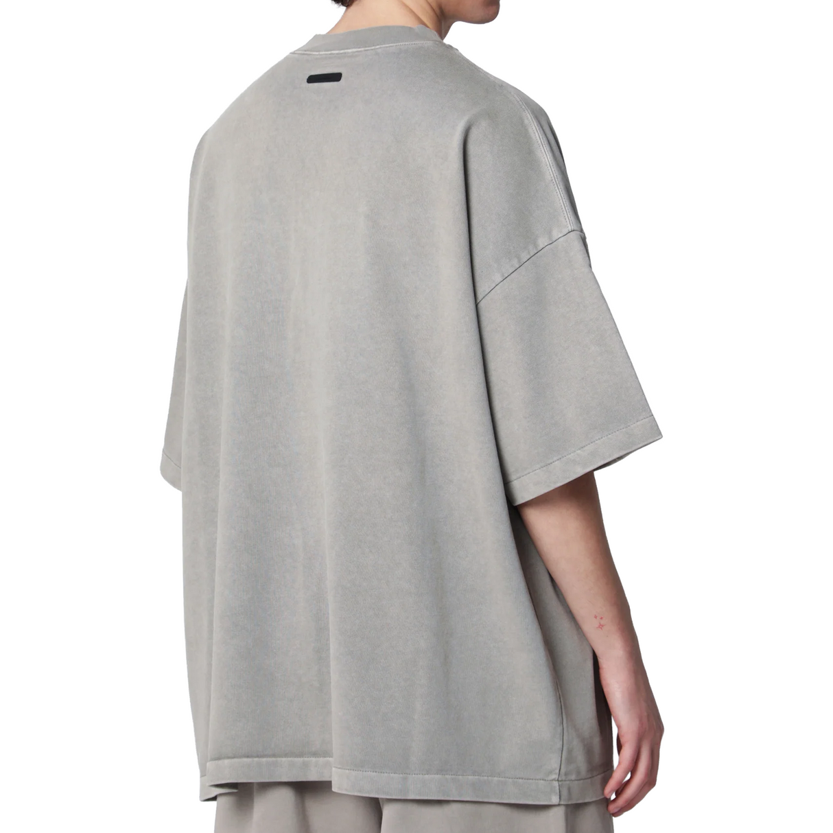 Fear of God Essentials Training 90s Heavyweight Tee in faded seal design, short sleeve, black cotton apparel with back graphic.