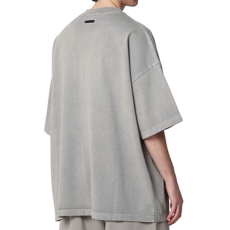 Fear of God Essentials Training 90s Heavyweight Tee in faded seal design, short sleeve, black cotton apparel with back graphic.