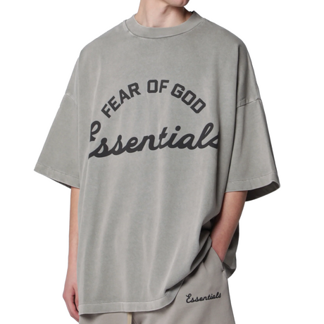 Fear of God Essentials Training 90s heavyweight short sleeve tee with faded seal logo, casual apparel for everyday wear.