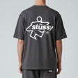 Black Stussy Surf Logo T-shirt showing the front with a surf-inspired logo graphic on the chest, casual apparel by Stussy.