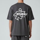 Black Stussy Surf Logo T-shirt showing the front with a surf-inspired logo graphic on the chest, casual apparel by Stussy.