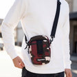 Supreme box logo sling bag in red camo fabric with adjustable strap and front logo patch, casual accessory for everyday use.