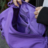 Supreme purple box logo utility bag with adjustable strap and multiple compartments, casual accessory for everyday use.