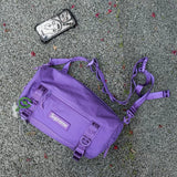 Supreme purple box logo utility bag with adjustable strap and multiple compartments, showcasing its durable fabric and bold design.